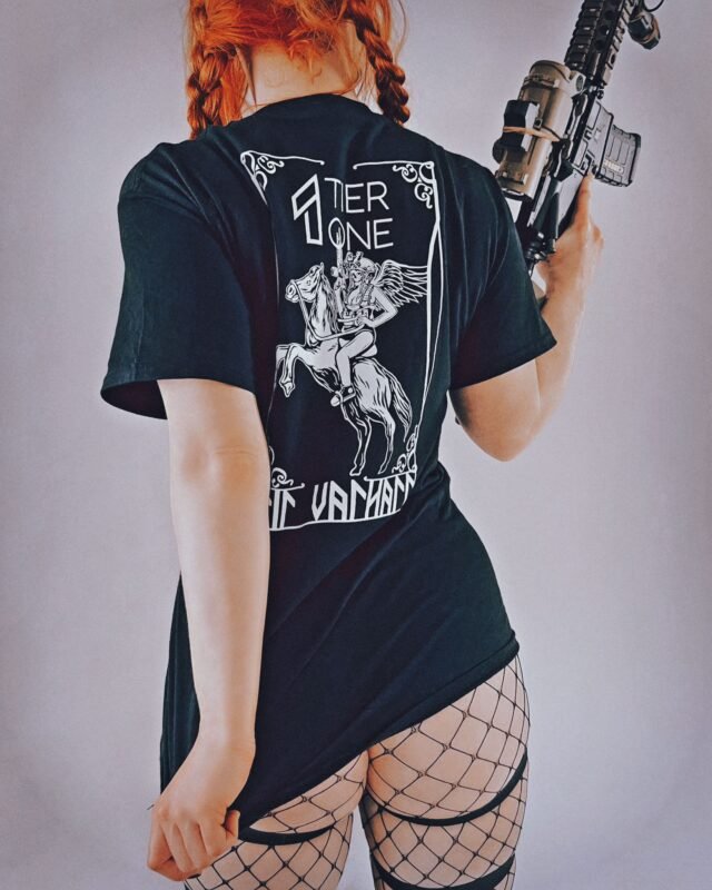 Frau trägt ein schwarzes TIER1ONE Tactical Shirt und posiert im modernen Urban-Streetwear-Look.